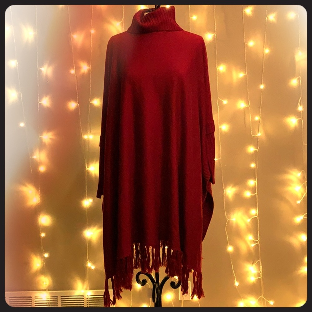 Red Poncho style turtleneck sweater.